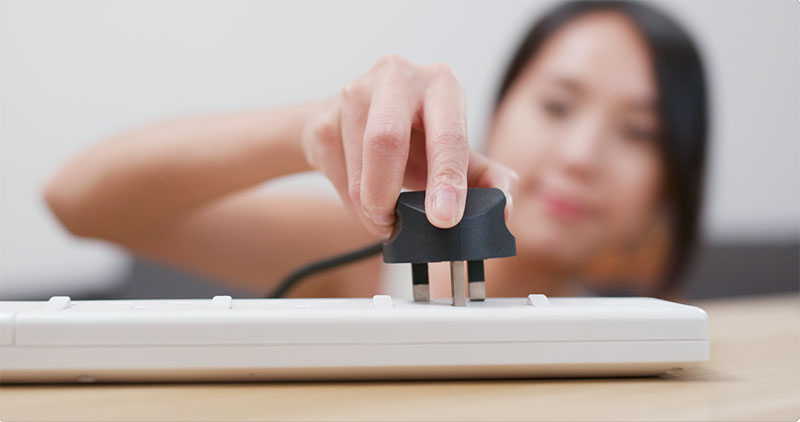 Women-Pluging-a-power-cord-into-a-power-strip